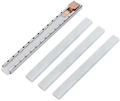 Metal holder with four chalk sticks.